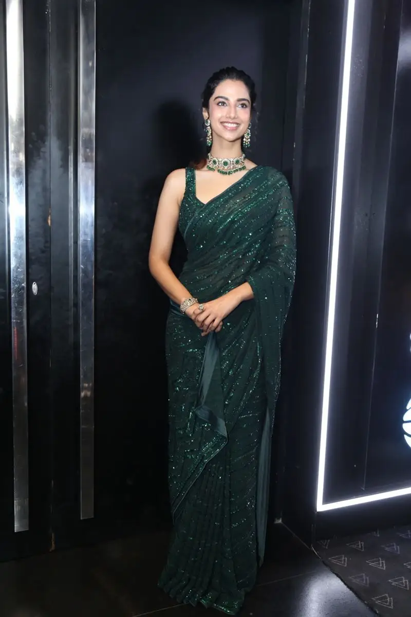 Meenakshi Chaudhary Wearing Beautiful Earrings Jewellery Green Saree